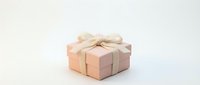 Elegant pink gift box with cream ribbon bow on white background for special occasions and celebrations.