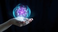 Human hand holding glowing holographic sphere with purple energy core and blue light effects on dark background for futuristic technology concepts.