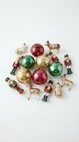 Vintage Christmas ornaments collection with colorful baubles, nutcracker soldiers and farm animals on white background for holiday decorating projects.