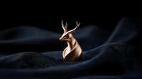 Elegant copper deer sculpture emerging from dark fabric waves creates dramatic contrast and luxury mood, artistic product photography on black background.