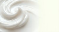 Creamy white swirl texture with smooth flowing curves creating elegant spiral pattern for cosmetic and skincare product backgrounds.