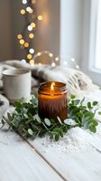 Cozy home spa scene with burning amber candle surrounded by eucalyptus leaves and sea salt on white wooden table with soft bokeh lights creating relaxing atmosphere.