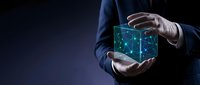 Businessman in formal suit holding glowing digital cube with network connections, representing technology innovation, data management, and digital transformation for corporate business solutions.