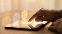 Person with dark skin tone selecting positive feedback rating on tablet device, expressing satisfaction and customer service experience.