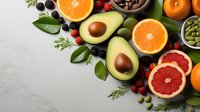 Fresh citrus fruits, avocado, berries and nuts arranged on light gray background. Healthy eating concept with colorful organic produce and superfoods.