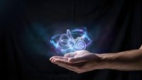 Glowing neon headphones floating above open palm against dark background. Digital music technology concept for streaming and audio entertainment.
