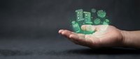 Hand holding glowing green digital icons of smart devices and IoT technology, symbolizing connected innovation and modern wireless solutions.