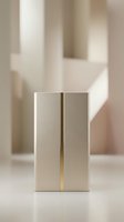 Elegant champagne gold metallic box with brass accent stripe on soft beige architectural background, luxury packaging concept for cosmetics or premium gifts.