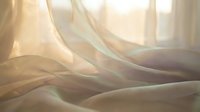 Soft flowing curtains with warm sunlight streaming through window creating dreamy atmosphere for interior design and home decor concepts.