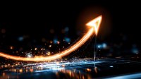 Glowing upward arrow trajectory with light trail effect against dark background with blue bokeh lights and reflective surface showing business growth concept.