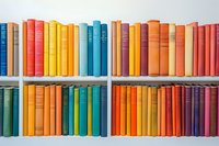 Colorful vintage books arranged in rainbow order on white wooden shelves, creating vibrant spectrum display for library, education, or home decor background.