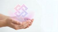 Cupped hands presenting glowing pink geometric pattern symbol with soft light effects for spiritual wellness and meditation concepts.