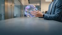 Businessman in suit holding glowing digital sphere with purple energy waves at modern office desk, representing innovation, technology, and future business solutions.