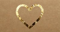 Golden foil heart shape on kraft paper background for romantic designs, wedding invitations, Valentine's Day cards and love-themed projects.