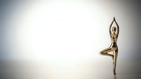Golden bronze female figure in tree yoga pose against minimalist white background for wellness meditation and fitness design concepts.