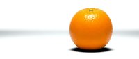 Fresh orange fruit with textured peel isolated on white background, suitable for food, nutrition, health and wellness marketing materials.