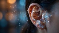 Human ear with digital circuit board overlay and glowing particles representing artificial intelligence and hearing technology innovation.