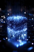 Glowing blue digital cube composed of light particles and data streams floating above reflective surface with bokeh effects in dark background. For tech concepts.