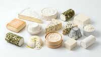 Assorted gourmet cheese collection featuring soft brie, aged cheddar, blue cheese, goat cheese and artisanal varieties on white background for culinary use.