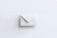 Minimalist white paper envelope casting soft shadow on light background, clean composition for business communication and correspondence concepts.
