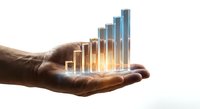 Business growth concept with glowing bar chart floating above open palm showing financial success and data visualization for presentations.