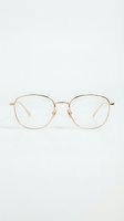 Gold-toned metal eyeglasses with clear lenses and geometric hexagonal frames, suitable for fashion, eyewear retail, and optical advertising purposes.
