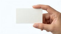 Hand holding blank white business card mockup template ready for custom design and branding on clean background for professional presentation.