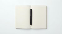 Open blank notebook with black pen on white background, ready for writing, planning, or creative projects.