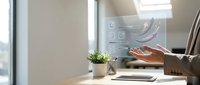 Businessman working at desk with laptop, potted plant, and smart home control interface displaying energy efficiency data and automation settings.