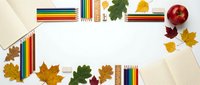 Autumn school supplies frame with colorful pencils, notebooks, ruler and fall leaves on white background. Back to school concept for educational design.
