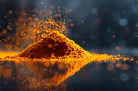 Vibrant orange turmeric powder heap with magical bokeh light effect and reflection on dark background, macro food photography for culinary and wellness concepts.