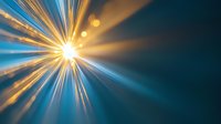 Radiant light burst with golden and blue rays emanating from bright center point creating dramatic sunburst effect against dark background. Dynamic energy concept.