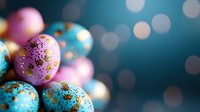 Festive Easter eggs decorated with gold glitter on blurred turquoise background with bokeh lights. Pink and blue pastel colors create magical holiday atmosphere.