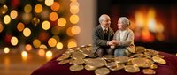 Senior Caucasian couple sitting together surrounded by golden coins with warm Christmas lights and fireplace creating cozy holiday financial planning atmosphere.