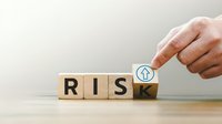 Hand placing wooden cube to transform word RISK into RISE on neutral background symbolizing business transformation and positive change management.