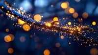 Magical golden sparkles and bokeh lights flowing on dark blue background create dreamy atmosphere for festive designs and holiday celebrations.