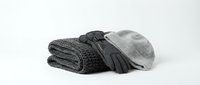 Cozy winter accessories set with knitted scarf, leather gloves and wool beanie hat in gray tones isolated on white background for seasonal fashion design.