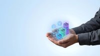 Businessman hand holding holographic digital cubes representing data technology, cloud computing and virtual reality concepts for modern business solutions.