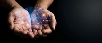 Cupped hands holding glowing digital network connections with light effects on dark background for technology and innovation concepts.