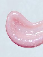 Glossy pink cosmetic gel smear with shimmering particles on white background, showcasing texture for skincare or makeup product advertising.