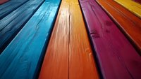 Vibrant multicolored wooden planks in perspective view showing textured surface with blue, orange, red and yellow stripes creating dynamic diagonal composition.
