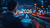 Businessman analyzing futuristic financial charts and 2026 projection data on digital tablet with glowing city lights and traffic trails in background at night.