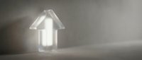 Glowing neon house icon on dark concrete surface, symbolizing smart home technology, energy efficiency, and real estate investment concepts for web and marketing.
