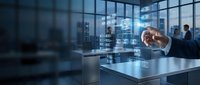 Businessman in formal attire analyzing digital data hologram in modern office with city skyline view, representing technology innovation and business analytics solutions.