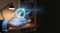 Business professional hand presenting glowing leadership compass icon with digital light effects in modern office environment for corporate training.