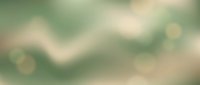 Abstract soft green and beige blurred background with bokeh light effects creating dreamy atmospheric mood for design projects and presentations.