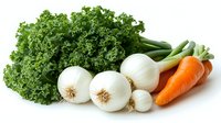 Fresh organic vegetables on white background - kale leaves, white onions and carrots. Clean eating and healthy food concept for cooking.
