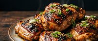 Glazed barbecue ribs with sesame seeds and fresh herbs on wooden cutting board. Grilled pork with caramelized sauce for restaurant menu and cooking.