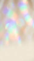 Soft pastel bokeh with blurred light circles in rainbow hues of purple, green, peach and cream on neutral beige background. Dreamy, out-of-focus effect suitable for overlays and design projects.