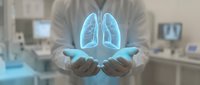 Medical professional holding glowing blue lungs hologram in modern healthcare facility. Digital health technology concept for respiratory medicine and diagnosis.